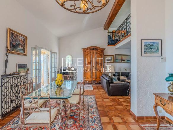 Intérieur d'une maison à Grasse avec un salon lumineux et une salle à manger.