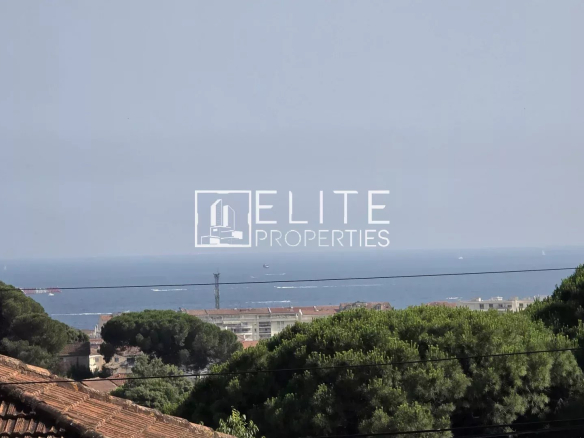 Sea view from a house in Cannes La Bocca, surrounded by trees and rooftops.