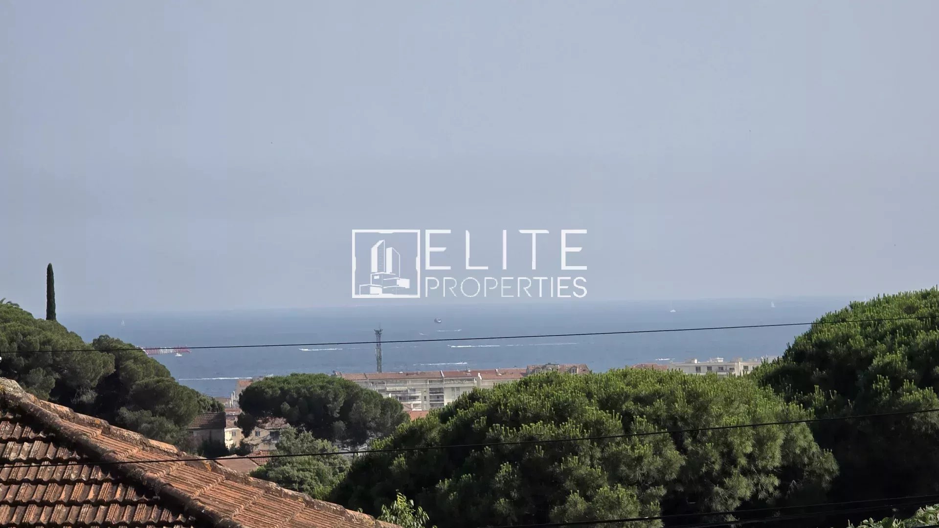 Sea view in Cannes La Bocca Sea view from a house in Cannes La Bocca, surrounded by trees and rooftops.