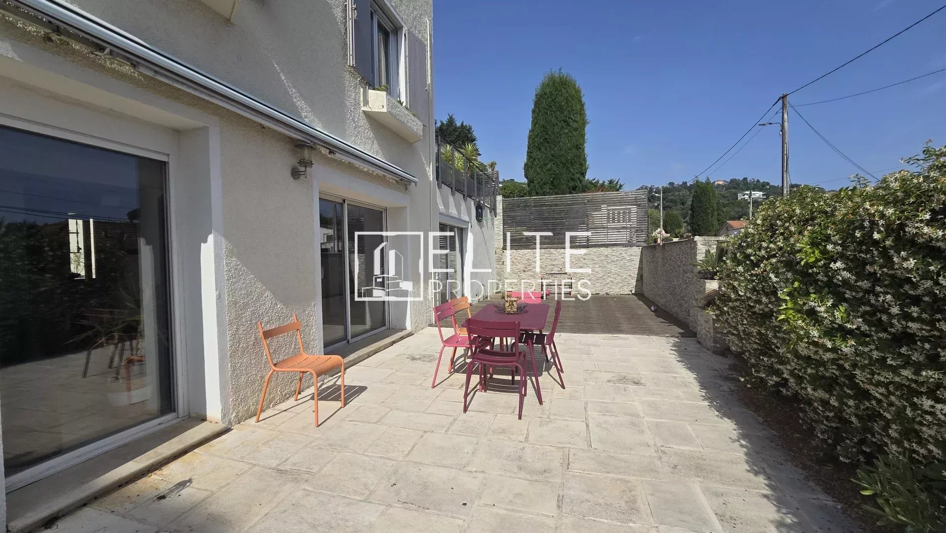 House terrace in Cannes Terrace of a house with garden furniture, overlooking a wooded outdoor area.