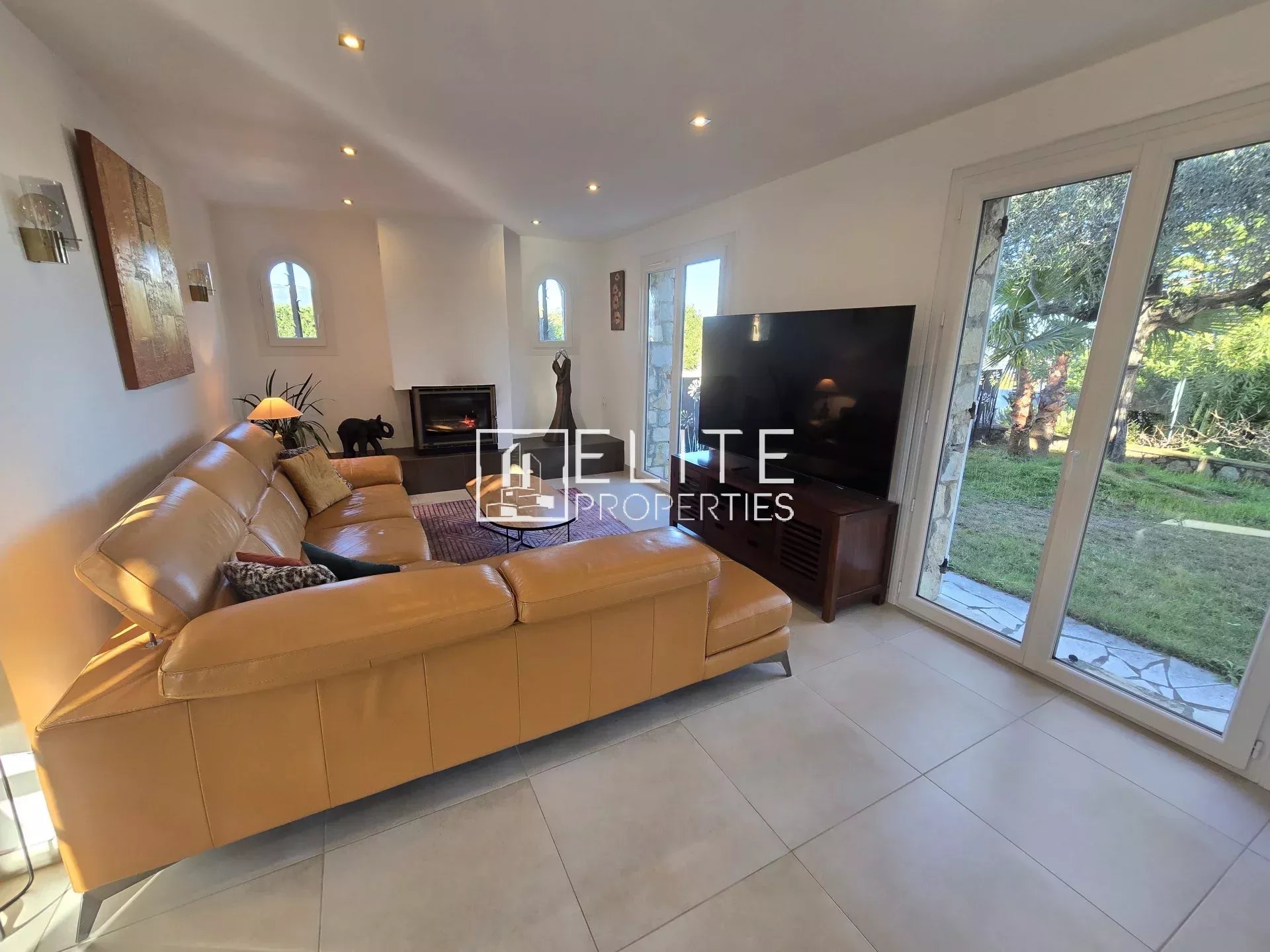 Salon d’une villa à Tanneron Intérieur d'une villa rénovée avec salon lumineux et canapé en cuir, vue sur jardin.