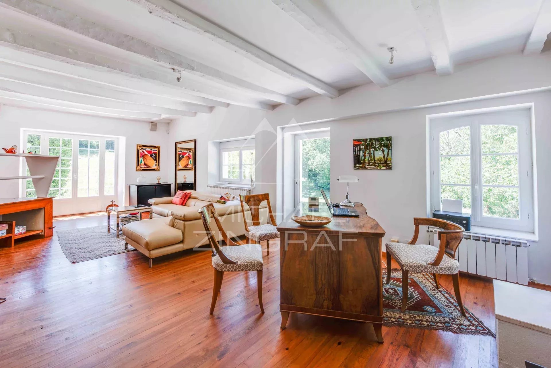 Interior of a renovated old farmhouse with bright living space and modern furniture.