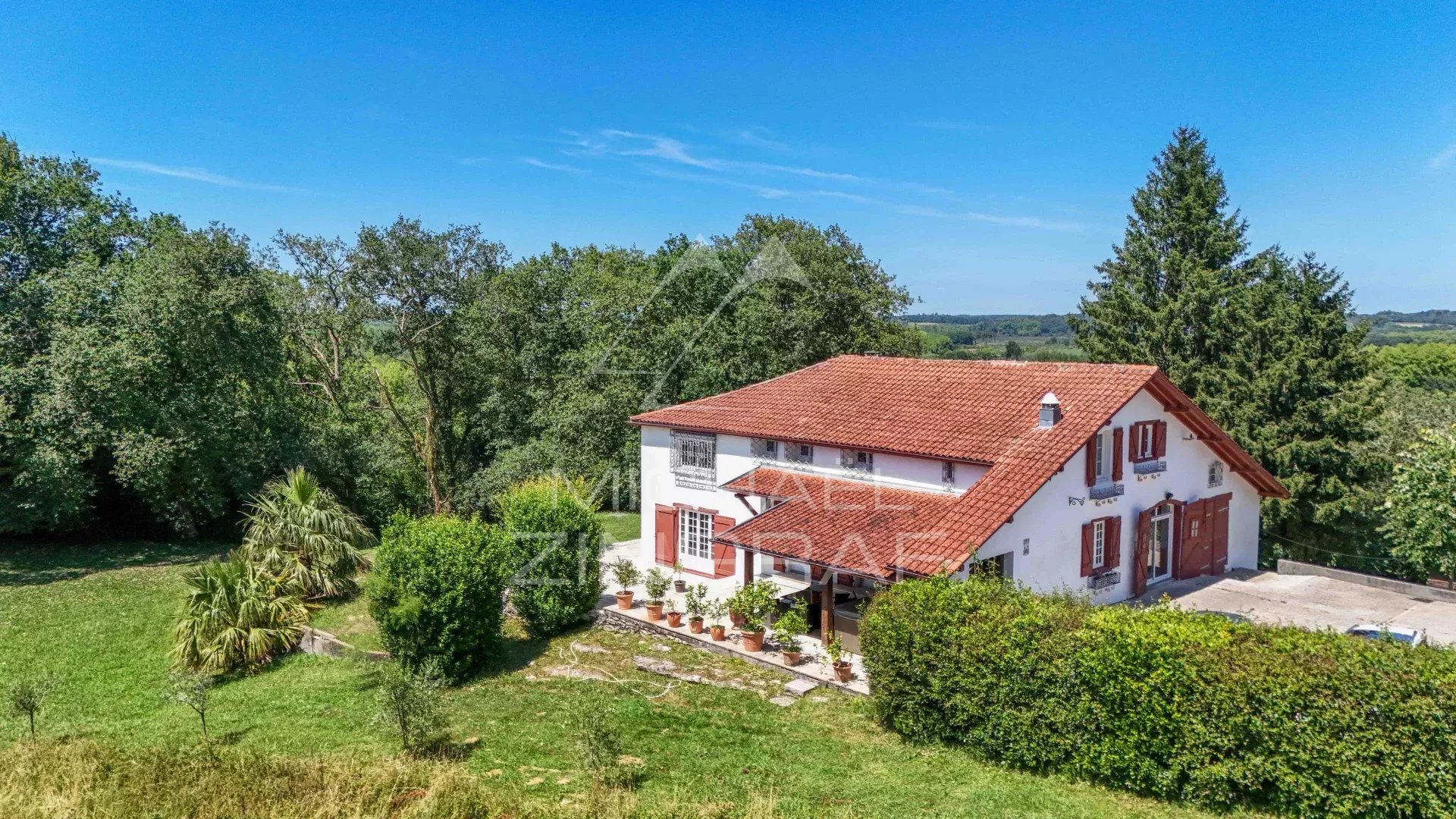 Renovated old farmhouse surrounded by greenery and forest, Basque Country.