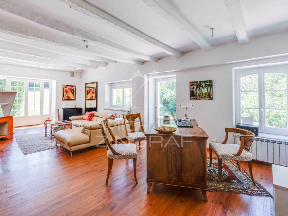 Intérieur d'une propriété équestre avec salon lumineux et bureau en bois