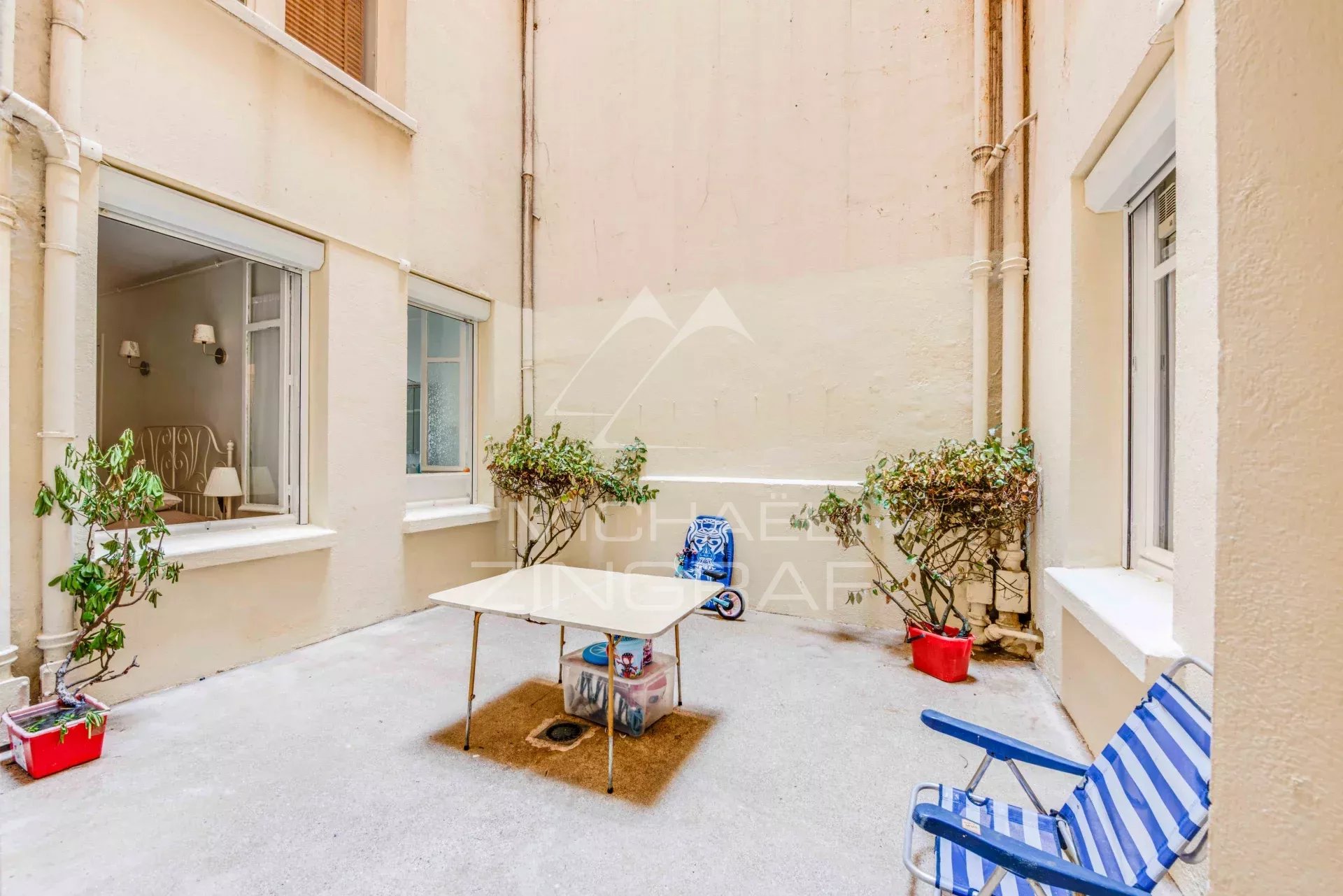 Patio d'un appartement de 105 m2 à Biarritz, avec chaises et plantes.