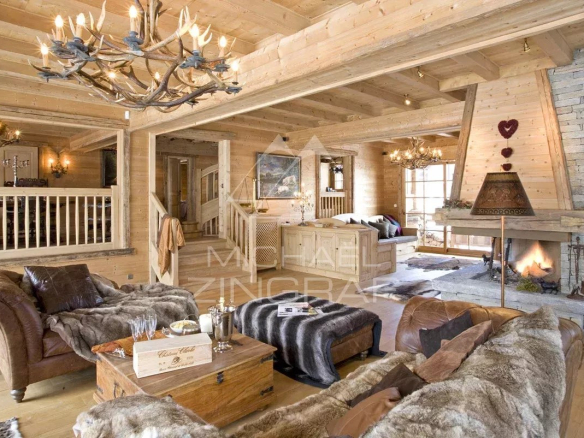 Intérieur d'un chalet en bois avec salon et cheminée, décoré dans un style montagnard.