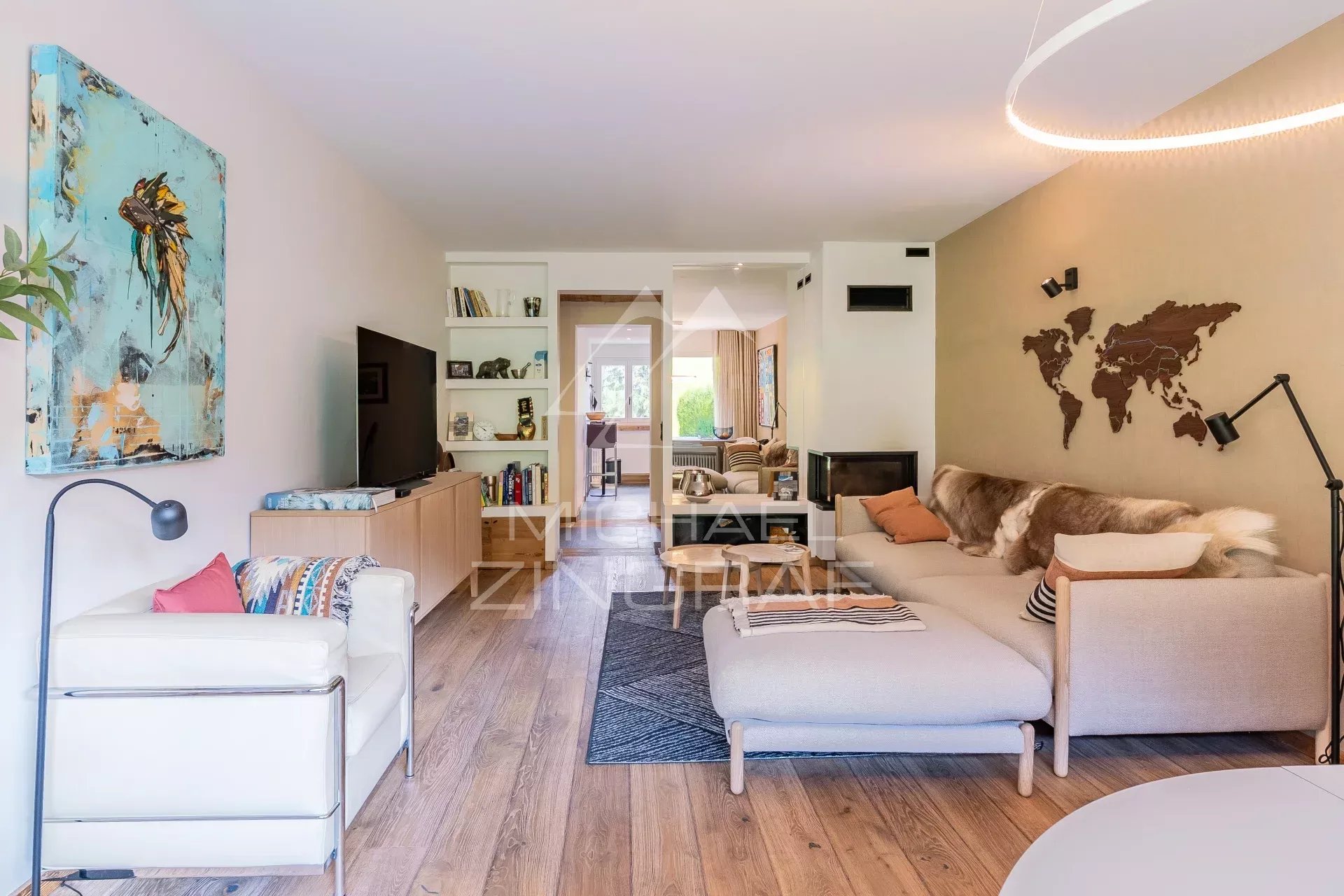 Salon lumineux d'un appartement rénové avec cheminée et décoration moderne à Megève.