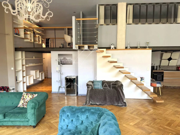 Interior of a renovated family loft in Lyon 6th arrondissement, with a bright living room and wooden stairs.