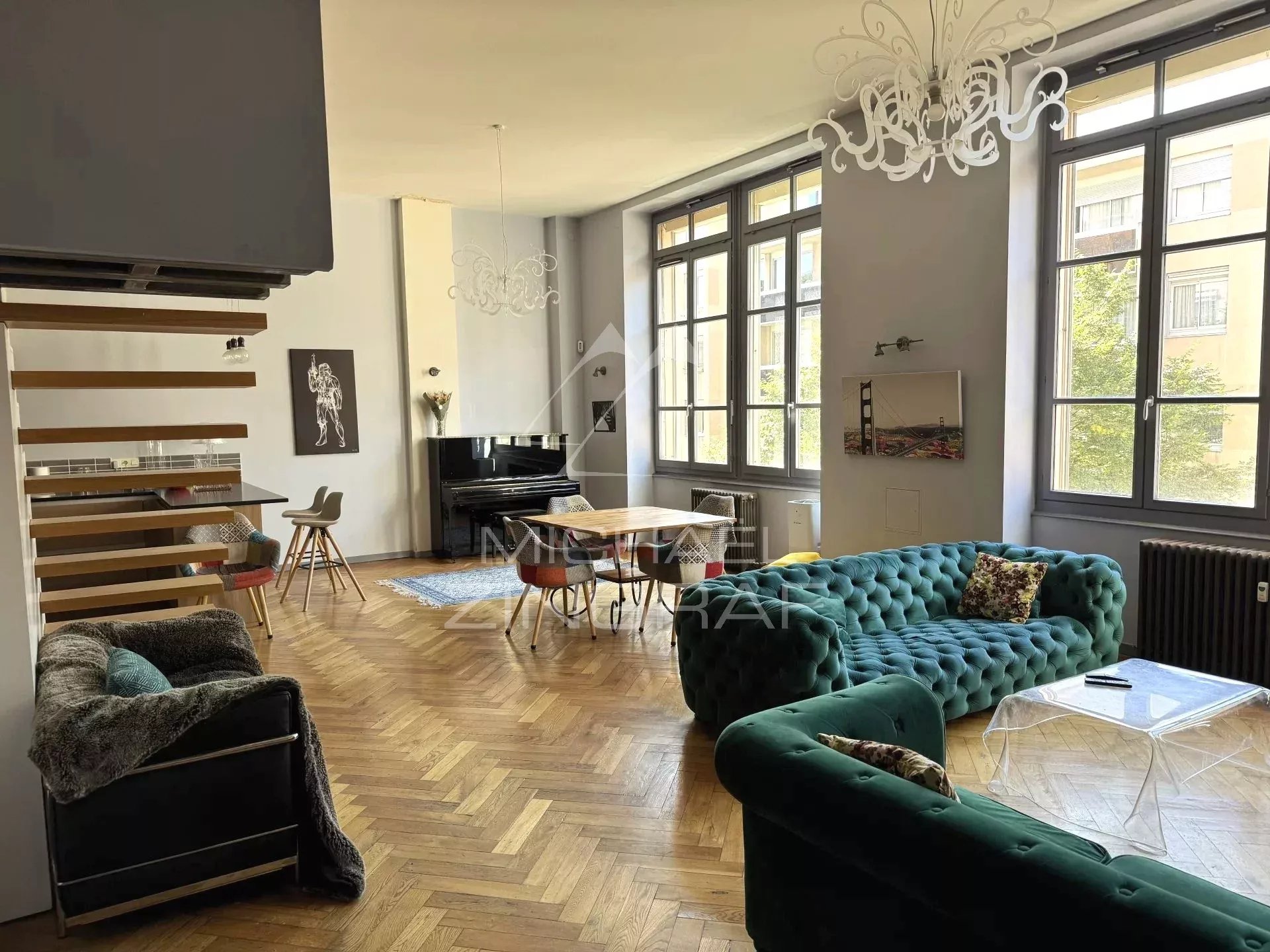 Interior of a renovated family loft in Lyon 6th arrondissement, with a spacious and bright living room and modern furniture.
