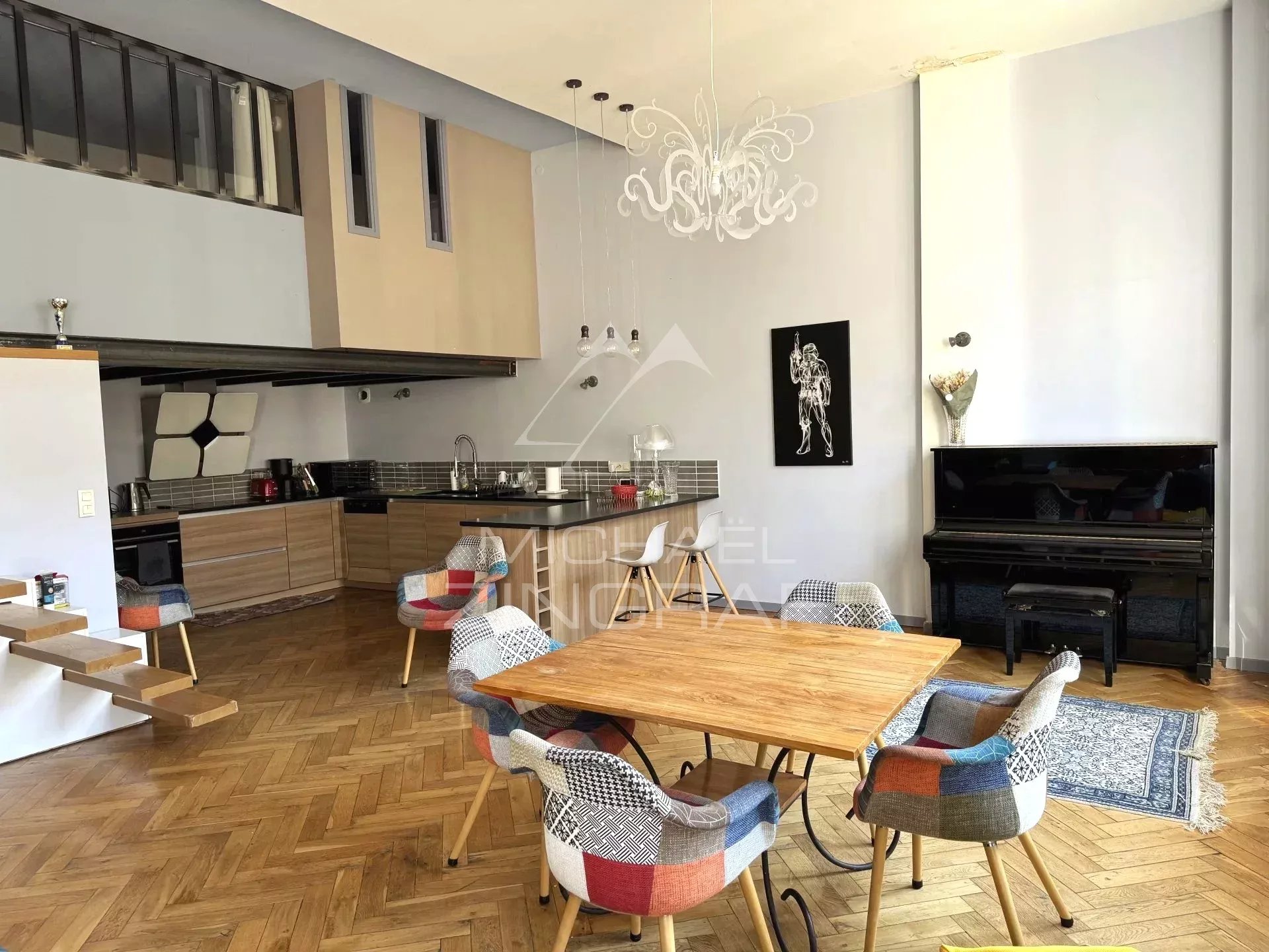 Interior of a renovated family loft with open kitchen and dining room, Lyon 6th arrondissement.