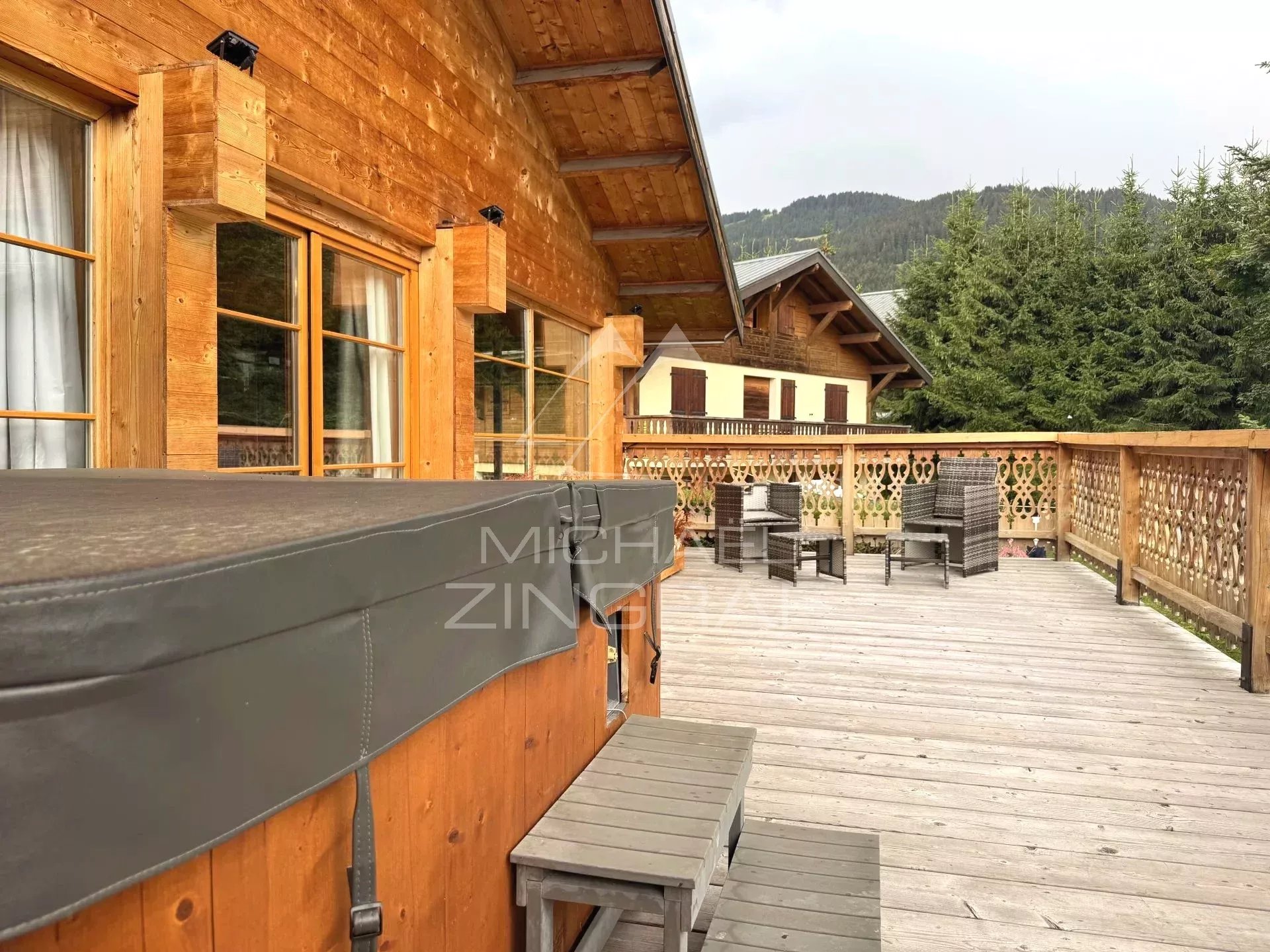 Renovated chalet in Megève Mont d'Arbois Terrace of a wooden chalet with jacuzzi and chairs in Megève Mont d'Arbois.