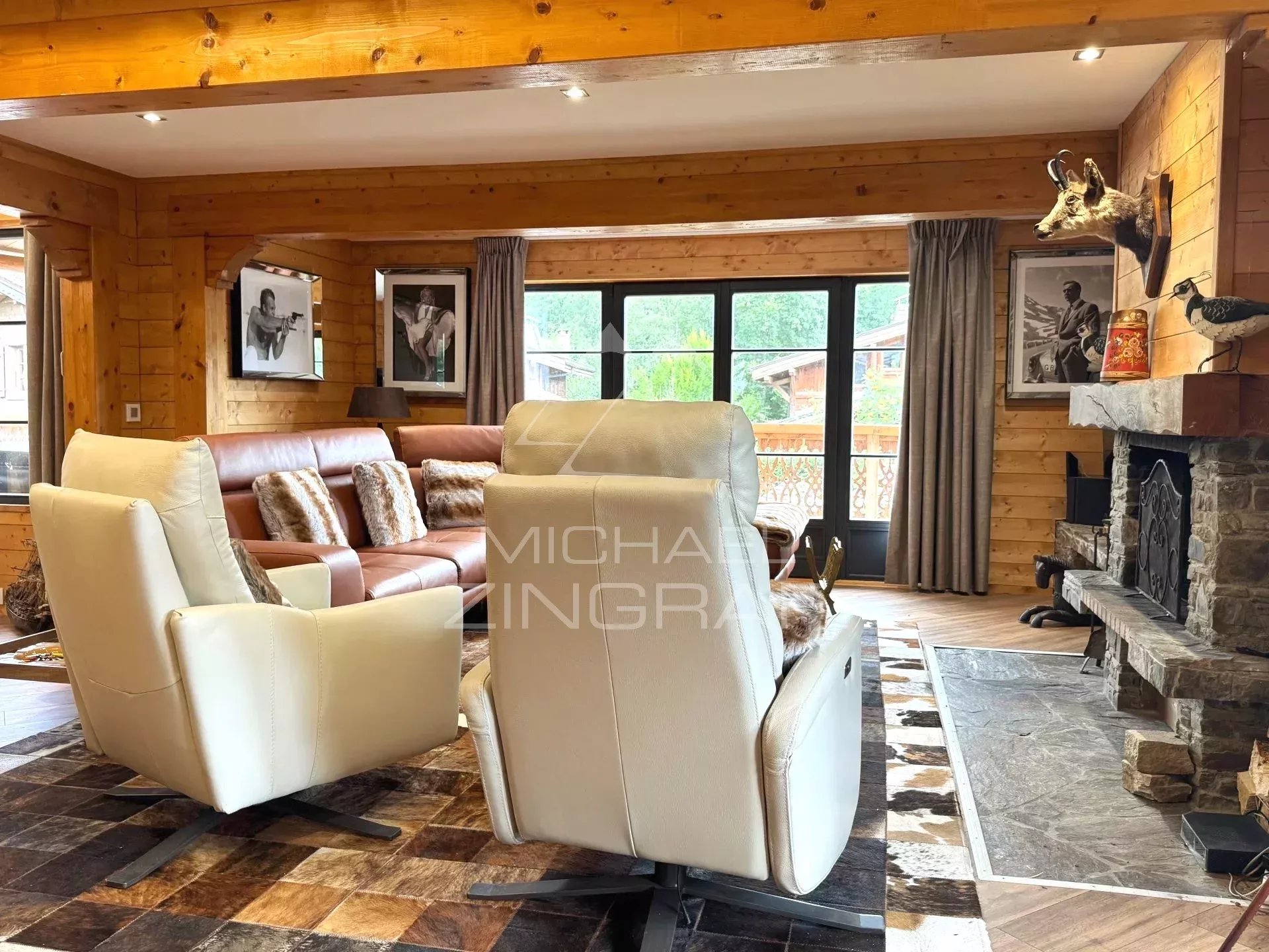 Renovated chalet in Megève Interior of a renovated chalet in Megève, with living room, fireplace and comfortable armchairs.