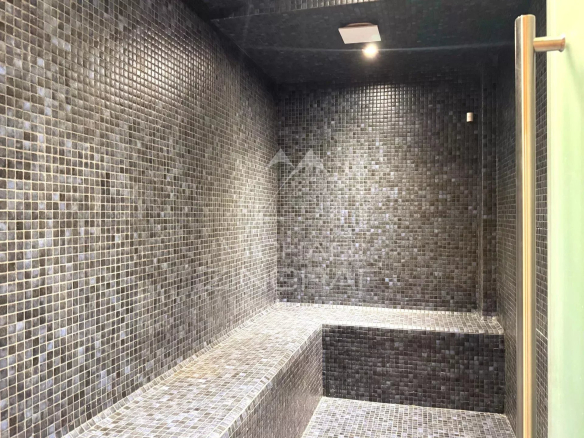 Interior of a mosaic sauna in a renovated chalet in Megève.