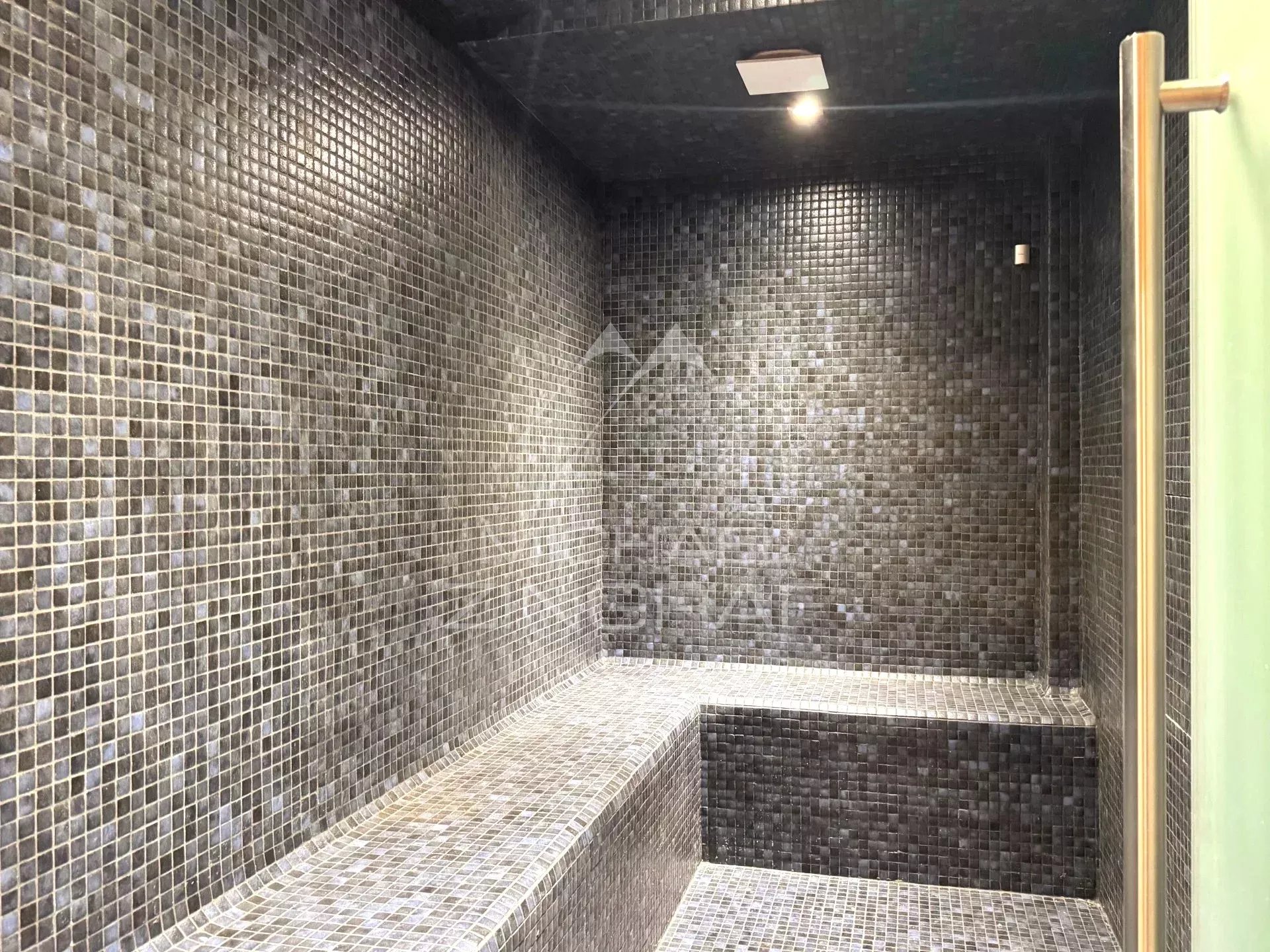 Sauna in a chalet in Megève Interior of a mosaic sauna in a renovated chalet in Megève.