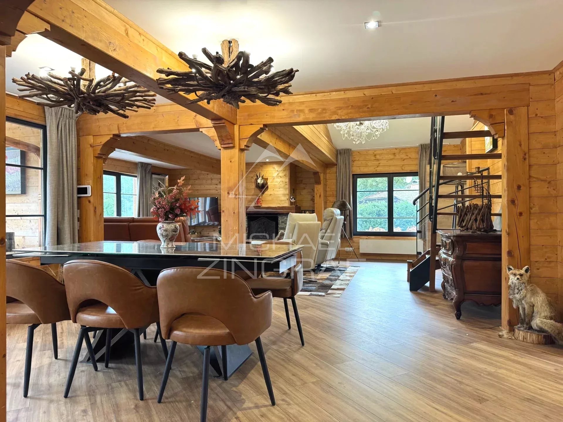 Renovated chalet in Megève Interior of a renovated chalet in Megève with a large dining room and a cozy living room.