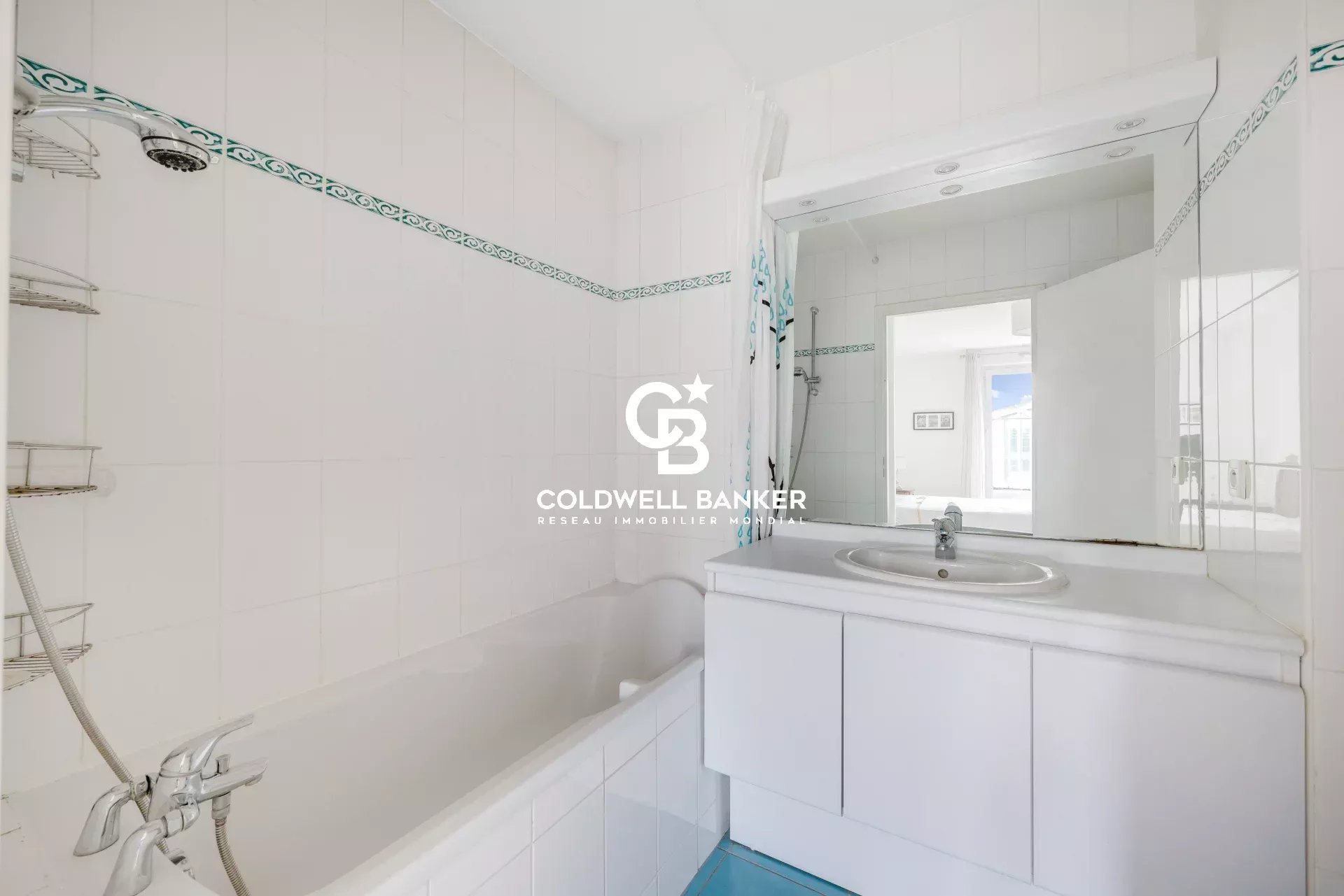 Bathroom with bathtub and mirror, white tiled walls.