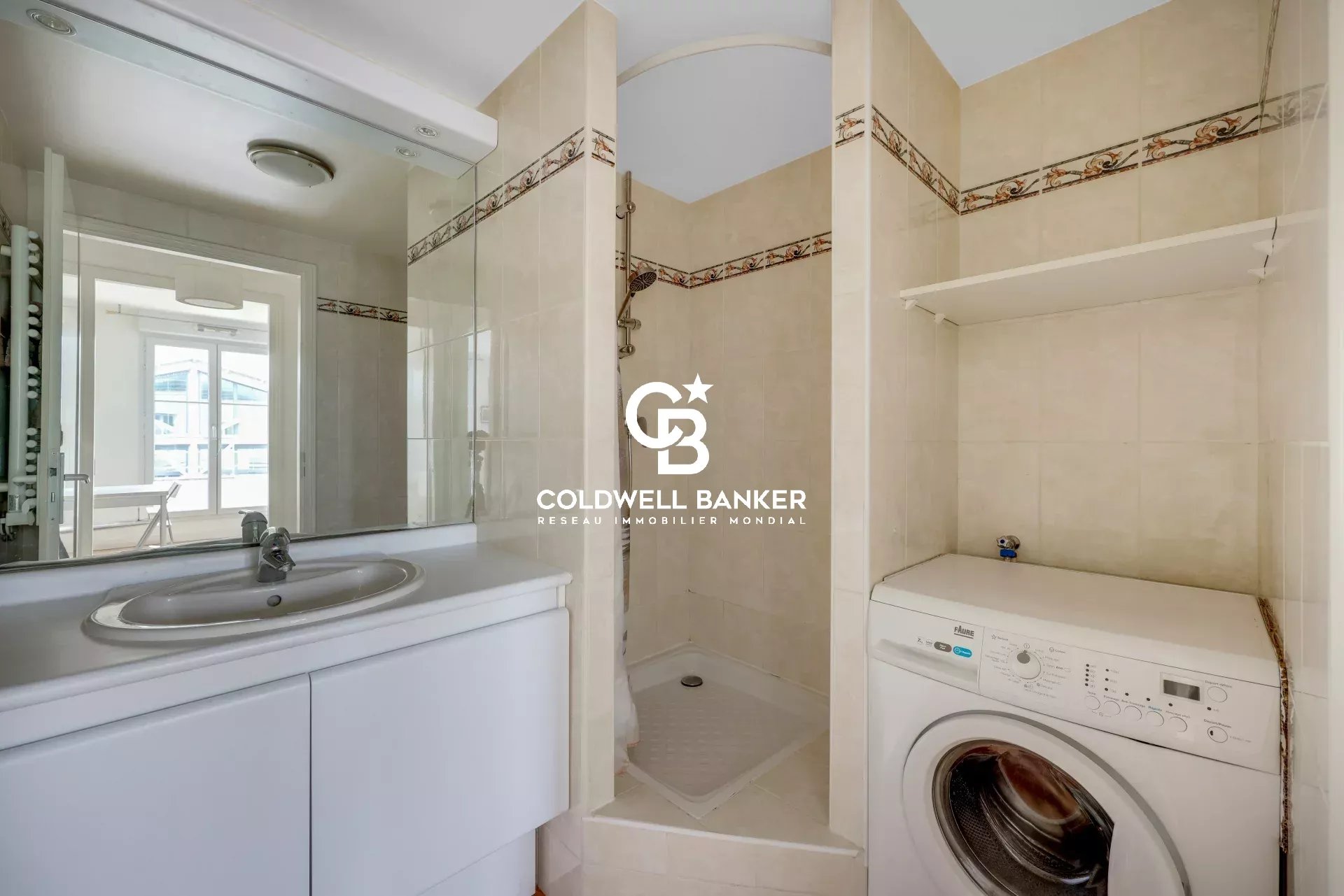 Bathroom with shower, sink and washing machine in a modern apartment.