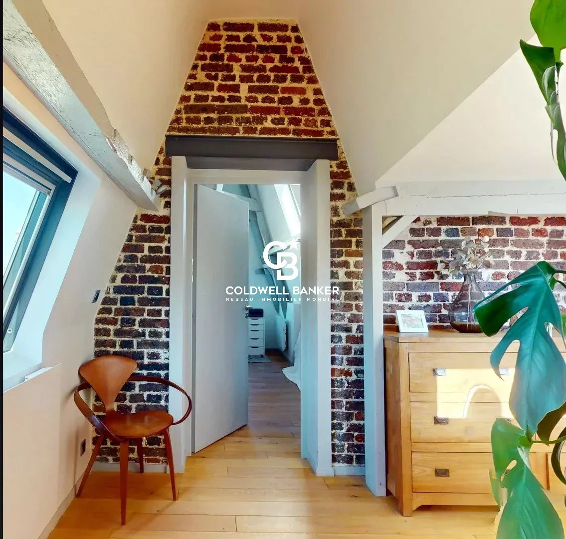 Intérieur d’un appartement au Château des Montalets Intérieur d'un appartement avec murs en briques et décoration moderne.