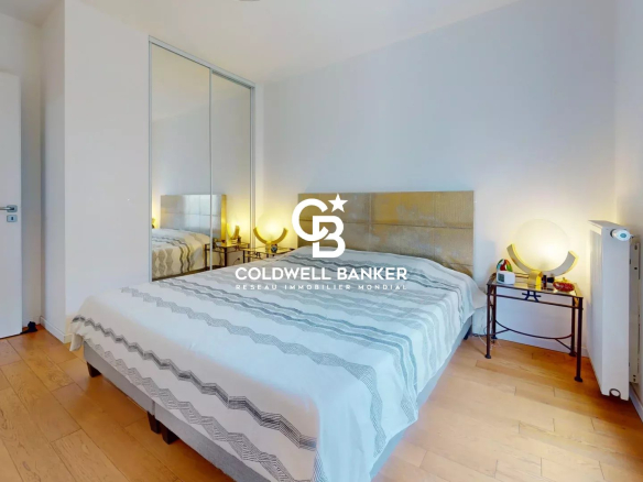 Chambre d'un appartement lumineux avec lit et décor moderne.