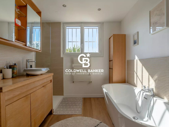 Modern bathroom with bathtub and wooden furniture