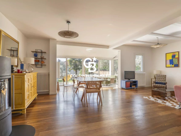 Bright interior of a house with living room, dining table and access to the garden.