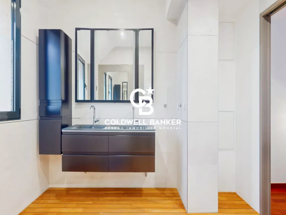 Modern bathroom with vanity unit and mirror, wooden parquet flooring.