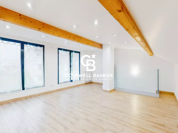 Interior of a contemporary house with a wooden floor and bright windows.