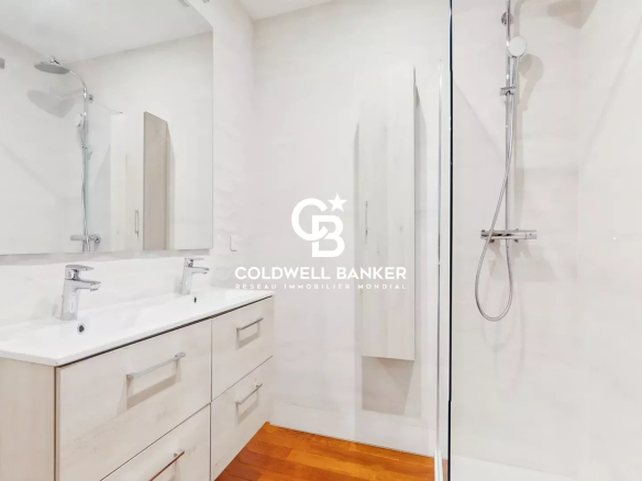 Modern bathroom with shower and double sink in a contemporary house.