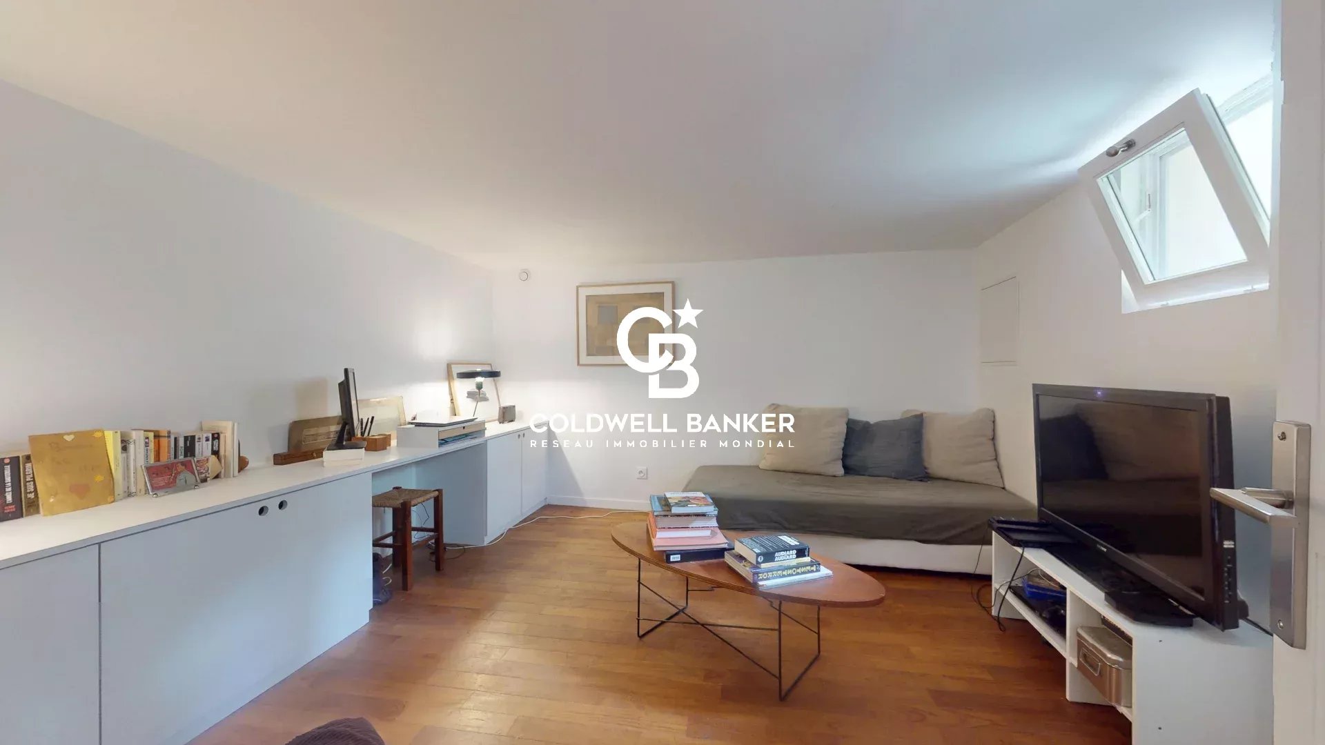 Salon d’une maison à Malakoff Intérieur d'une maison à Malakoff avec un salon lumineux et un canapé.