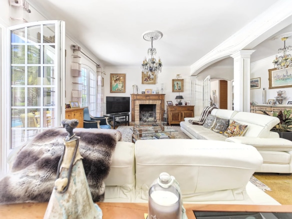 Interior of a renovated bastide with bright living room and fireplace, Le Cannet.