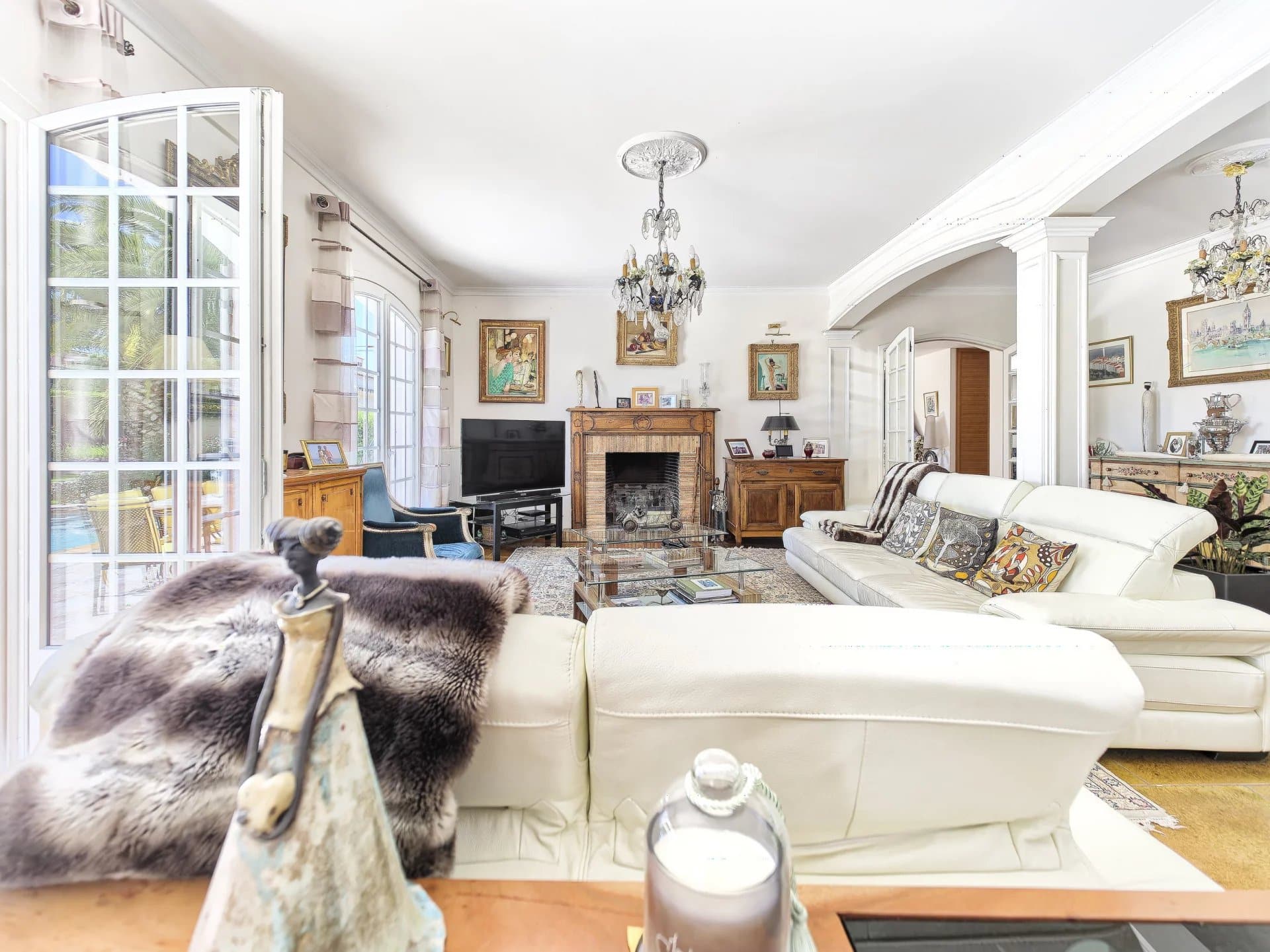 Interior of a renovated bastide with bright living room and fireplace, Le Cannet.