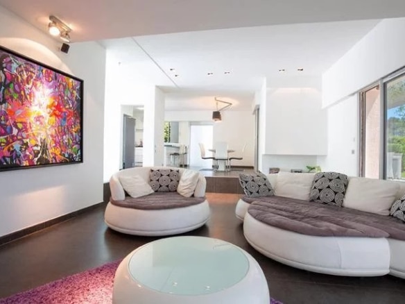 Interior of a detached villa in Mougins with a modern living room and a colorful piece of art on the wall.