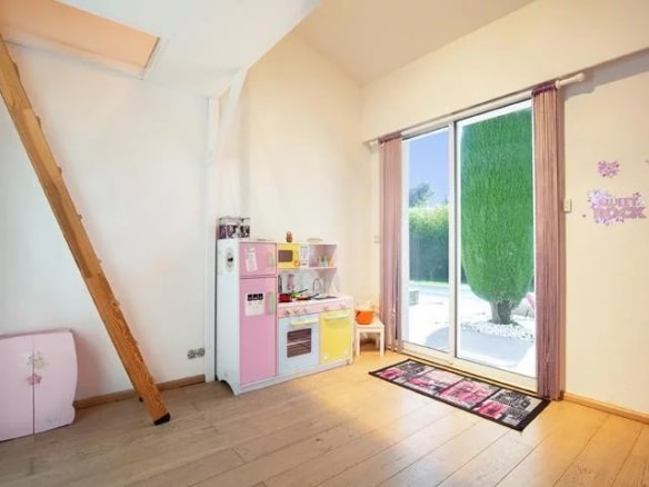 Interior of a villa in Mougins with a children's kitchen and access to the outdoor swimming pool.