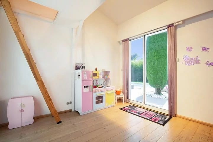 Interior of a villa in Mougins with a children's kitchen and access to the outdoor swimming pool.