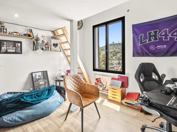 Bright room with desk, armchair and sporty decor.