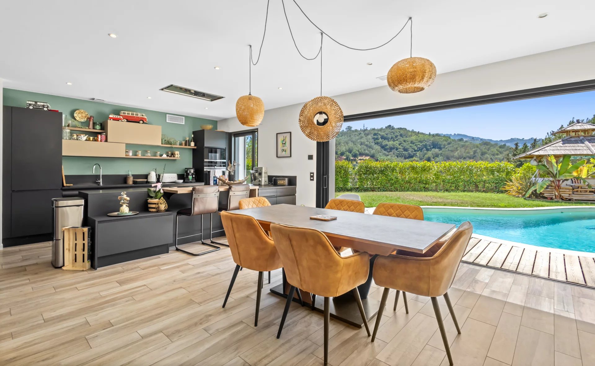 Interior of a villa in Auribeau-sur-Siagne Interior of a modern villa with fitted kitchen and dining room, overlooking the pool and garden.