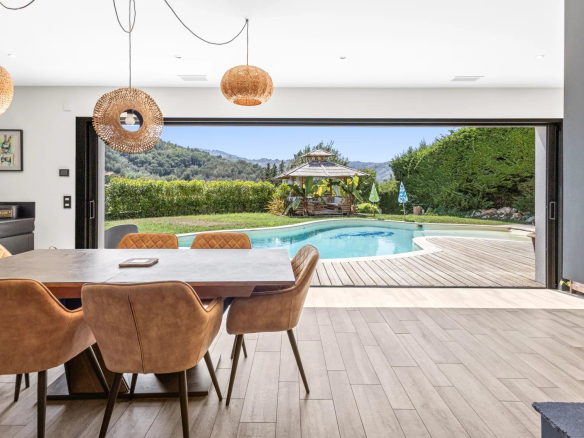 Interior of a villa in Auribeau-sur-Siagne with a view of the swimming pool and garden.
