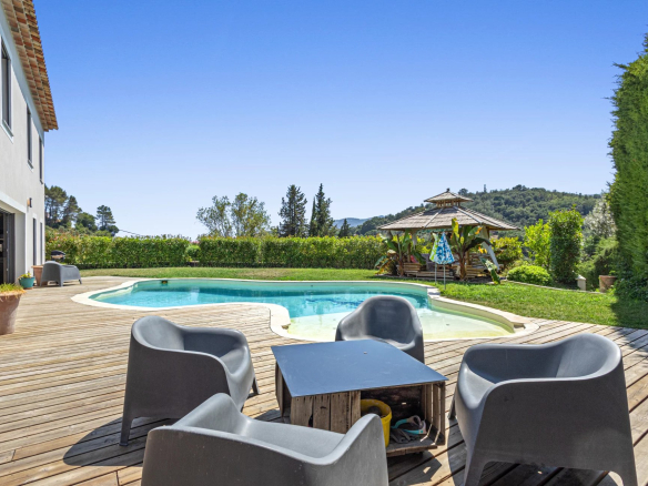 Villa with swimming pool and terrace in Auribeau-sur-Siagne, surrounded by greenery.