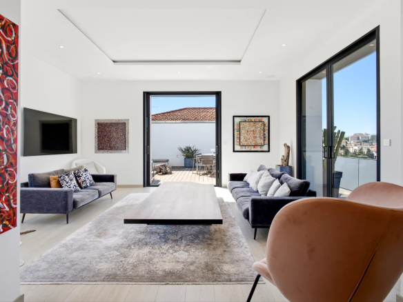 Interior of a renovated villa with modern living room and terrace in Cannes.