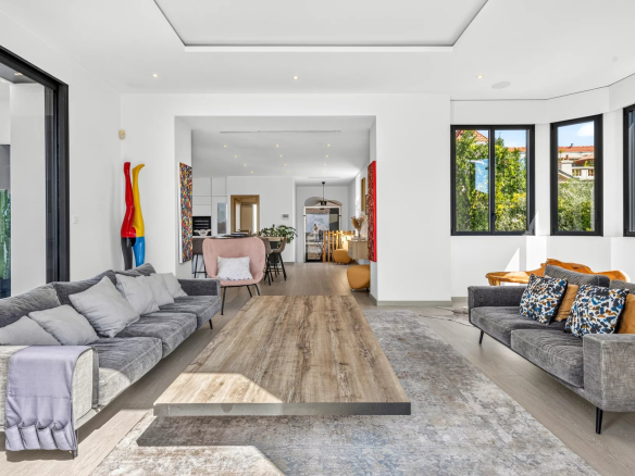 Interior of a renovated Belle Époque villa with a bright and modern living room in Cannes.