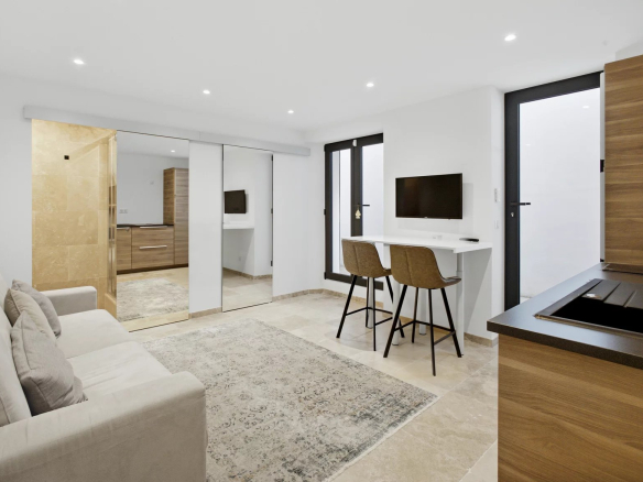 Interior of a modern villa with a bright living room, an office and an open kitchen.