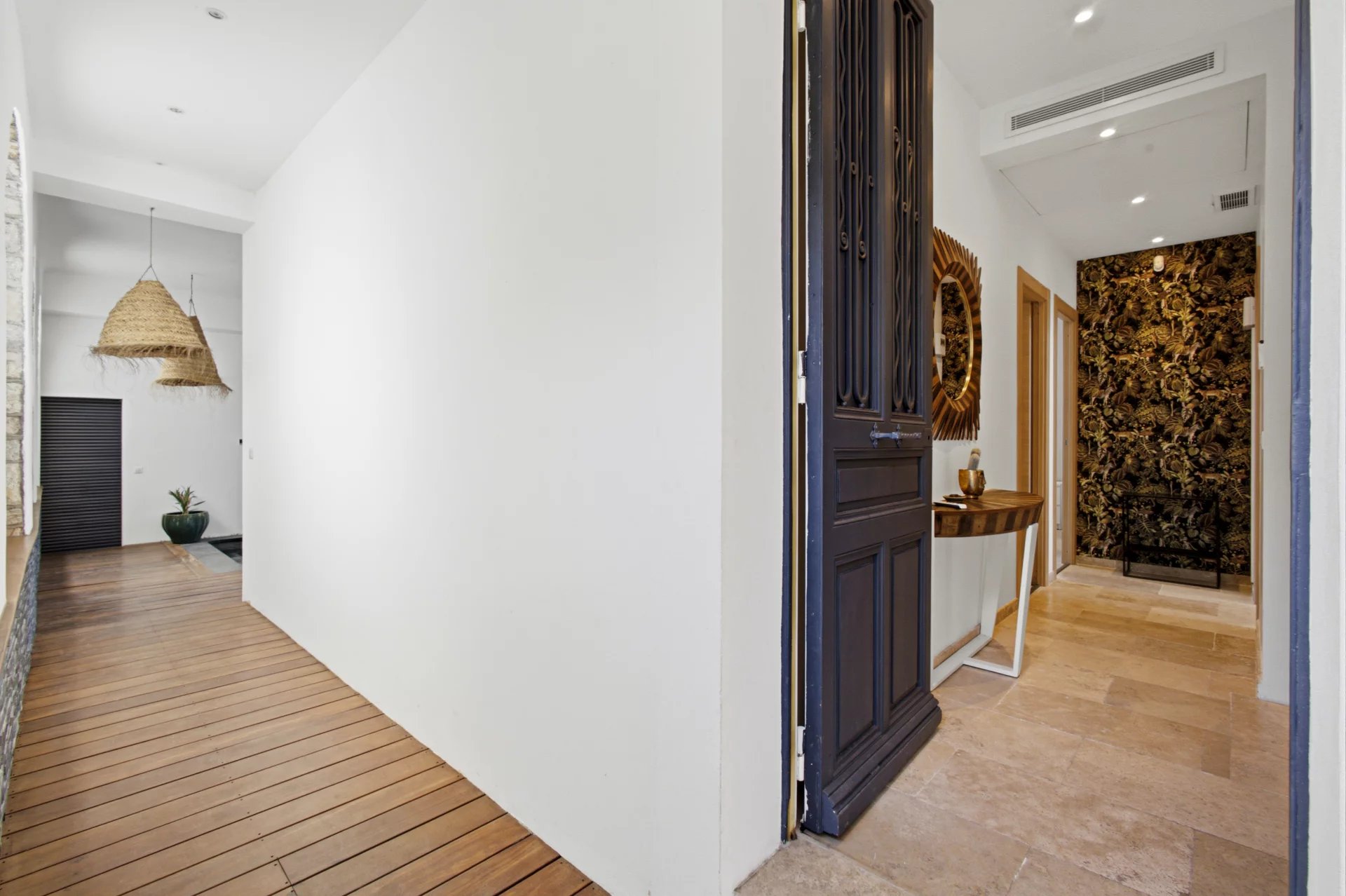 Interior of a villa in Petit Juas Interior of a renovated Belle Époque villa with a bright entrance hall and wooden flooring.