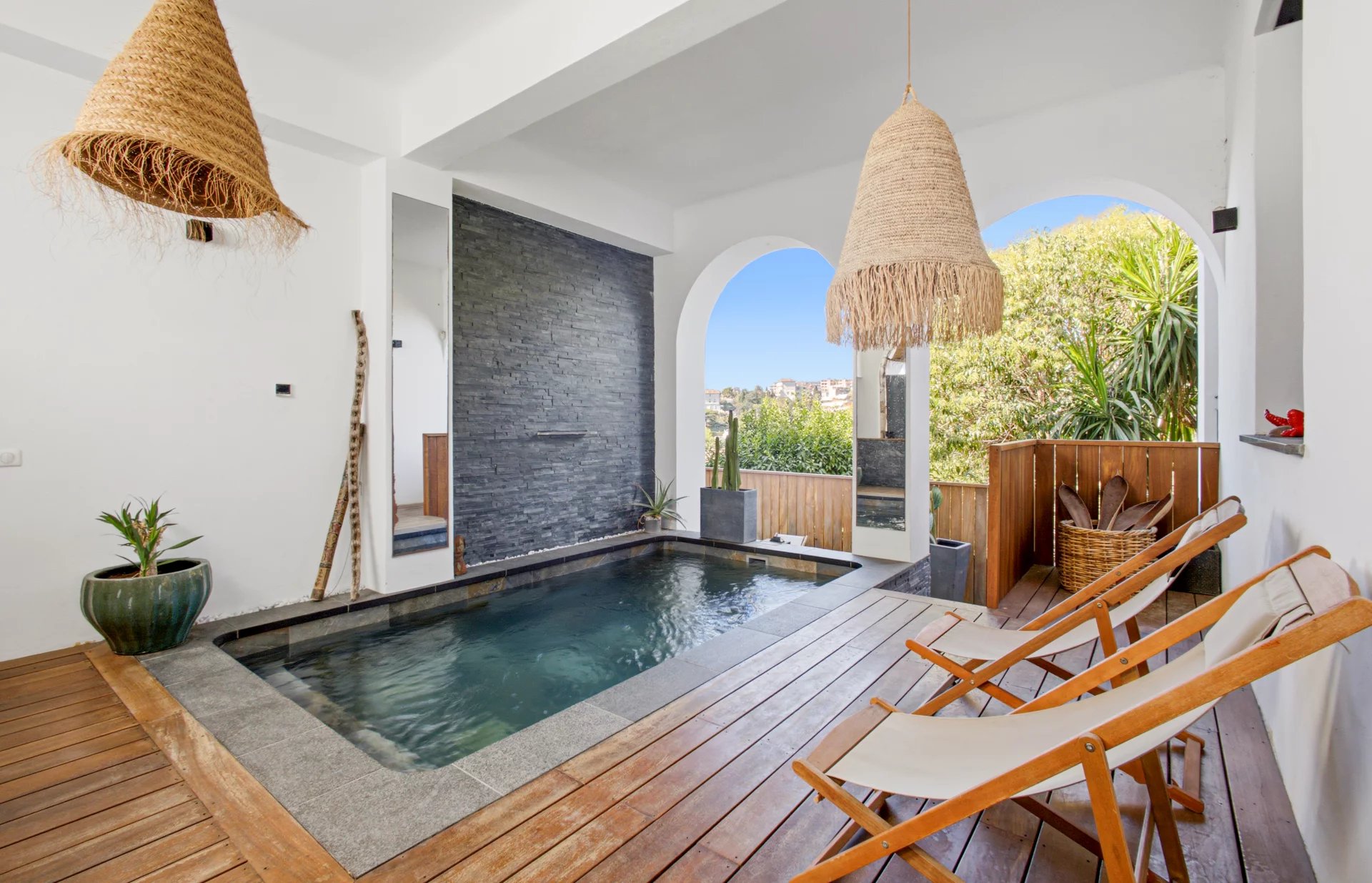 Interior of a villa with a swimming pool Interior of a villa with swimming pool, sun loungers and modern decor.
