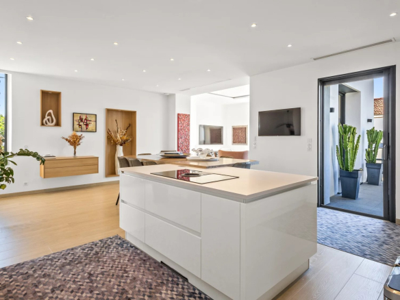 Interior of a renovated Belle Époque villa with open kitchen and bright space.
