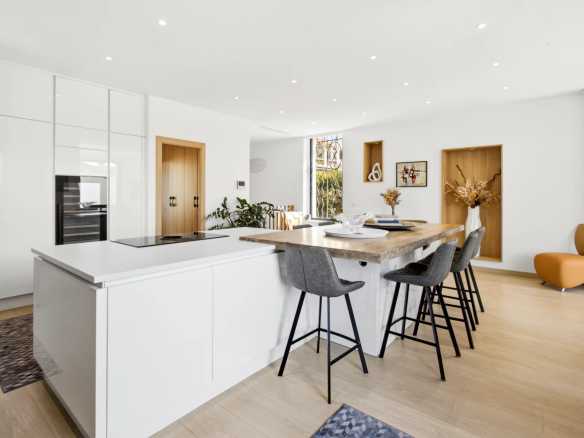 Interior of a modern villa with open kitchen and central island, contemporary furniture.