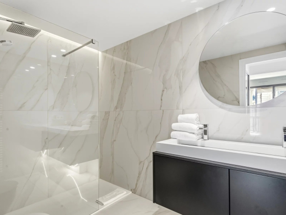Modern shower room with walk-in shower and sink in a renovated studio in Cannes.