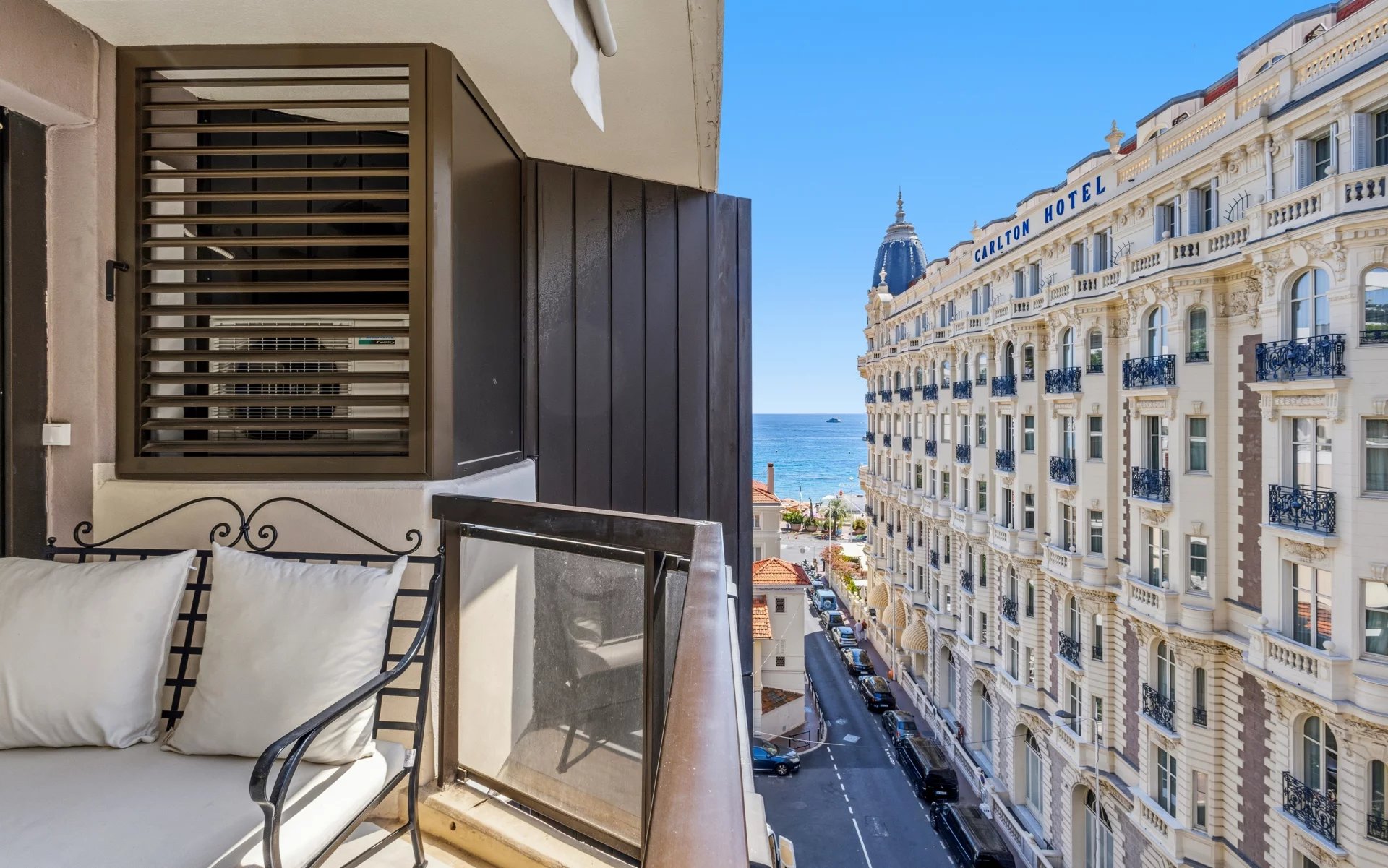 Renovated studio with a view in Cannes View from the balcony of a top-floor studio in Cannes, with a side sea view and the Carlton hotel building.