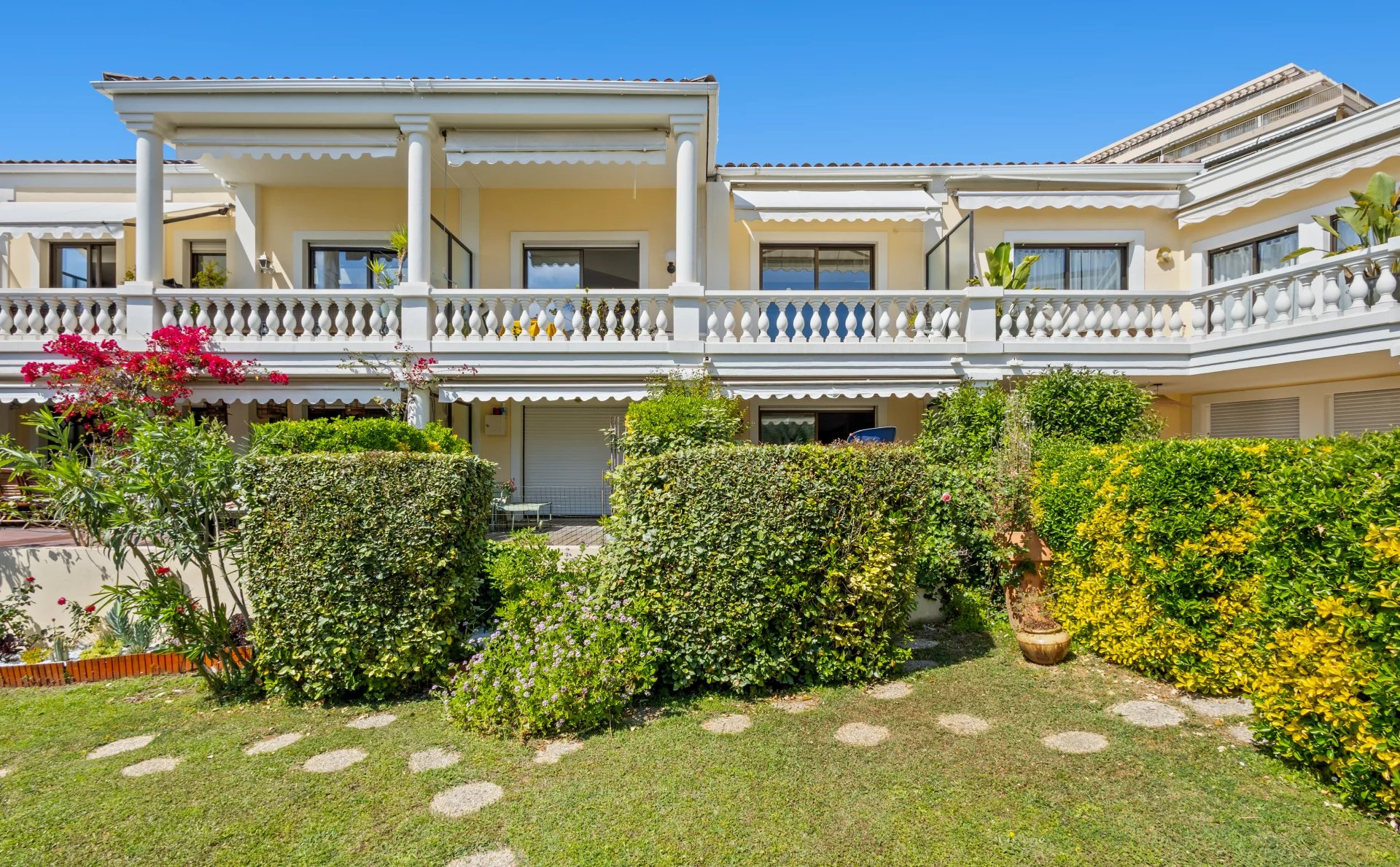 Vue extérieure d'un appartement en duplex avec jardin et balcons à Cannes.