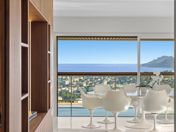 Panoramic sea view from an apartment in Le Cannet, with dining room and modern furniture.