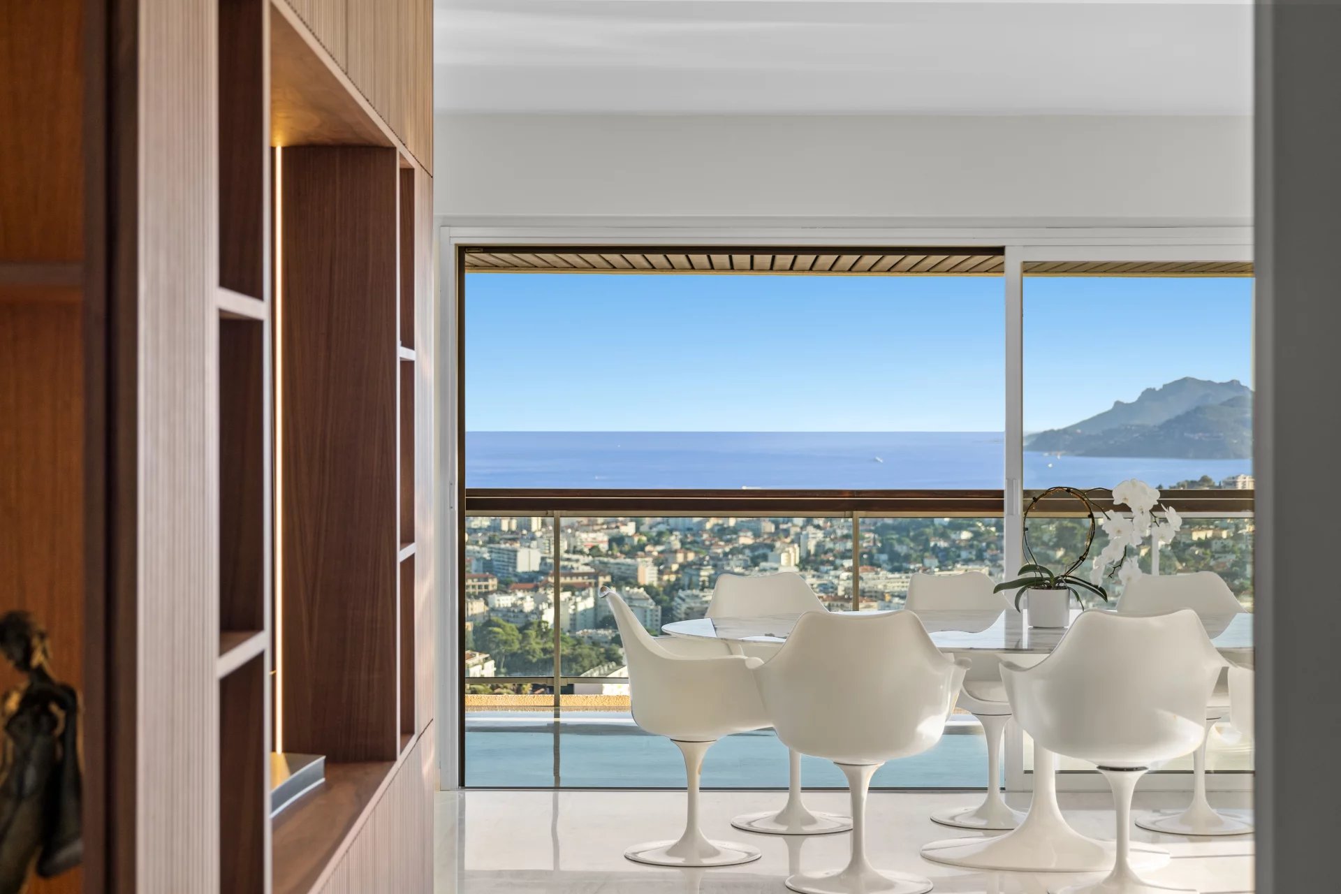 Panoramic sea view from an apartment in Le Cannet, with dining room and modern furniture.